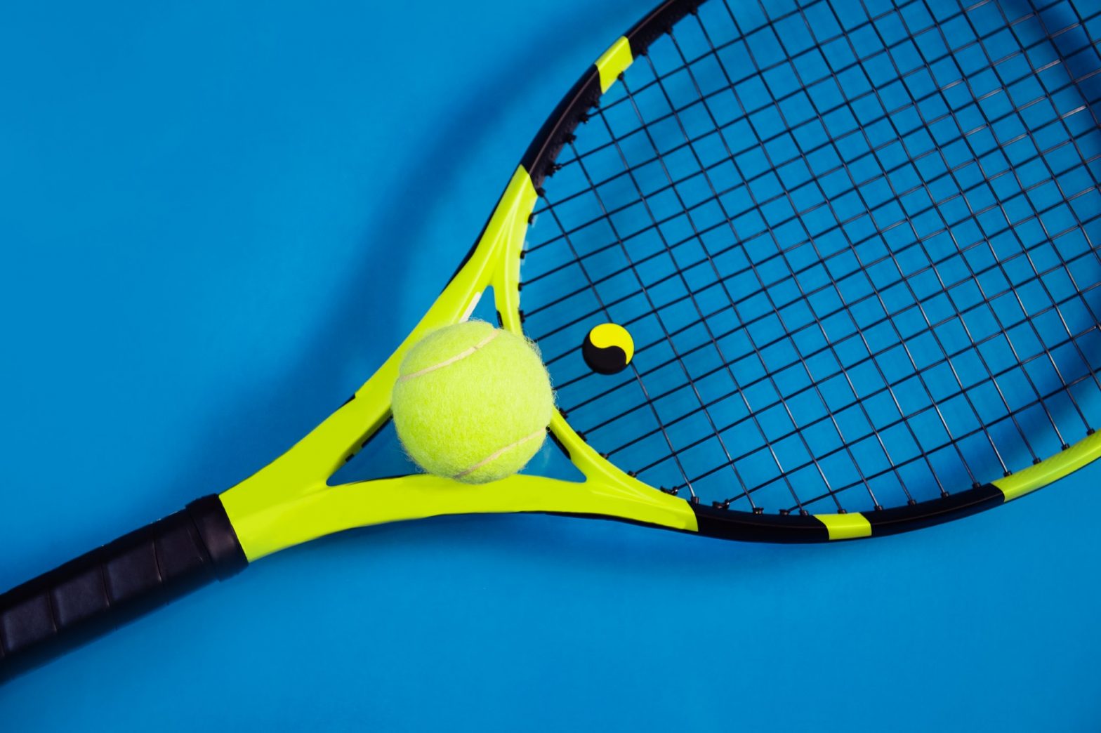 Tennis racket with a ball top view copy space
